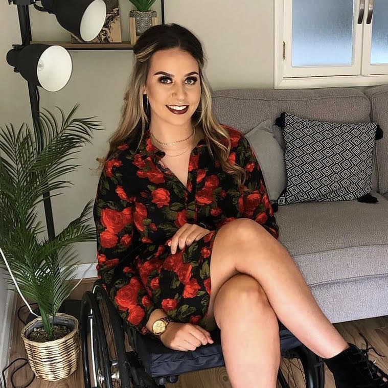 Jennie Berry, a white female with blonde hair facing the camera smiling sitting in an wheelchair 