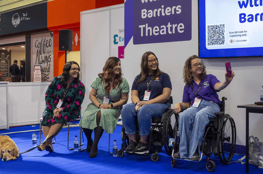 Four female speakers at the Naidex conference taking a selfie together.